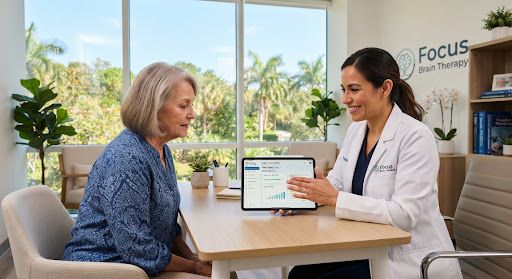 A patient working through a cognitive rehabilitation task with a therapist in a calm, naturally lit clinic room.